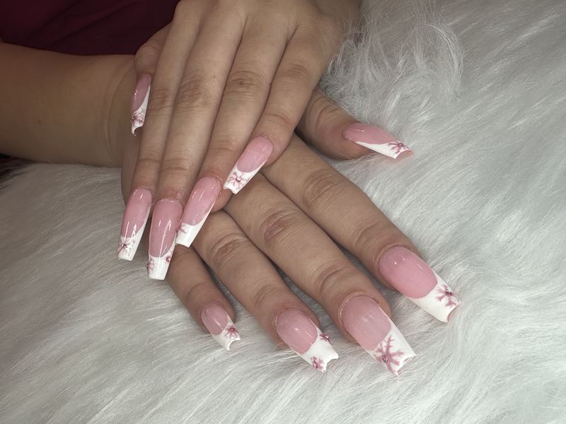 A fresh coffin-shaped Gel-X set with hand-painted snowflake art